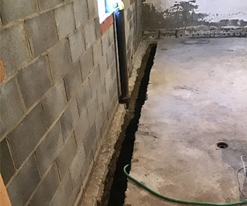 Interior drain tile installation in WNY, collect groundwater and prevent flooding